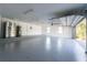 Spacious garage featuring epoxy floors, an extra refrigerator, and an automatic garage door at 2721 Ingeborg Ct, Windermere, FL 34786