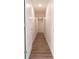 Long hallway with modern flooring, white walls, and streamlined doors at 2721 Ingeborg Ct, Windermere, FL 34786