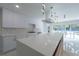 Modern kitchen with white cabinetry, marble backsplash, and large quartz countertop island at 2721 Ingeborg Ct, Windermere, FL 34786