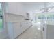 Beautiful kitchen featuring stainless steel appliances, marble backsplash, and white cabinetry at 2721 Ingeborg Ct, Windermere, FL 34786