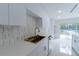 Kitchen with quartz countertops, marble backsplash, and stainless steel sink at 2721 Ingeborg Ct, Windermere, FL 34786