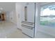 Modern refrigerator with custom handles, white cabinetry, and natural light at 2721 Ingeborg Ct, Windermere, FL 34786