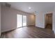 Open-concept living room featuring wood floors and a sliding glass door to outdoor space at 2721 Ingeborg Ct, Windermere, FL 34786