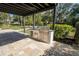 Stainless steel outdoor kitchen with grill, sink, and storage under a pergola and paver patio at 2721 Ingeborg Ct, Windermere, FL 34786