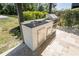 Outdoor stainless steel kitchen with built in barbeque grill, sink, counter space and tiled flooring at 2721 Ingeborg Ct, Windermere, FL 34786