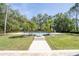 Private backyard swimming pool featuring lush palm trees and beautiful landscaping at 2721 Ingeborg Ct, Windermere, FL 34786