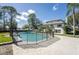 Landscaped backyard featuring a swimming pool with surrounding black safety fence at 2721 Ingeborg Ct, Windermere, FL 34786