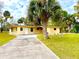 Charming single-story home with a well-manicured lawn, long driveway, and a beautiful palm tree at 2815 W Orange Blvd, Kissimmee, FL 34741