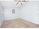 Bright bedroom featuring a ceiling fan, ample natural light, and neutral carpet at 3203 Victoria Ln, Eustis, FL 32726