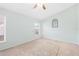 Bright bedroom featuring a ceiling fan, ample natural light, and neutral carpet at 3203 Victoria Ln, Eustis, FL 32726