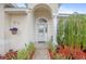 Inviting front entrance with decorative glass door, column and manicured landscaping at 3203 Victoria Ln, Eustis, FL 32726