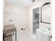 Laundry room with ceramic tile flooring, utility sink, folding table, wire shelving, and view to the garage at 3203 Victoria Ln, Eustis, FL 32726