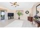 Spacious living room with neutral paint, ceramic tile flooring, ceiling fan, and sliding doors to an outdoor patio at 3203 Victoria Ln, Eustis, FL 32726