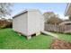 Backyard shed with a ramp set on a lawn, offering extra storage at 3203 Victoria Ln, Eustis, FL 32726