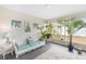 Bright sunroom featuring a wicker couch, plants, and an area rug, creating a relaxing indoor-outdoor space at 3203 Victoria Ln, Eustis, FL 32726