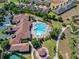 Aerial view of the community pool with lounge chairs, manicured landscaping, and nearby amenities at 3289 Saloman Ln, Clermont, FL 34711