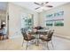 Inviting dining area with tile flooring, large windows, sliding glass doors, and a glass-topped table at 3289 Saloman Ln, Clermont, FL 34711