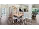 Bright dining room with wood floors, decorative chandelier, and large window with natural light at 3289 Saloman Ln, Clermont, FL 34711