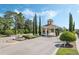 Elegant gated community entrance featuring a guardhouse, fountain, and lush landscaping at 3289 Saloman Ln, Clermont, FL 34711