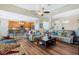 Open-concept living room with wood floors flowing into a stylish kitchen with bar stool seating at 3289 Saloman Ln, Clermont, FL 34711