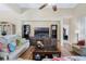 Inviting living room featuring wood floors, a ceiling fan, and a custom built-in entertainment center at 3289 Saloman Ln, Clermont, FL 34711