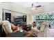 Comfortable living room featuring a ceiling fan, a fireplace and a view of the screened lanai at 3289 Saloman Ln, Clermont, FL 34711