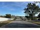 Residential street view showcasing houses, parked cars, and a glimpse of a lake in the distance at 3336 Pell Mell Dr, Orlando, FL 32818