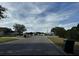 Neighborhood street view with well-maintained lawns, houses, and a serene sky at 3336 Pell Mell Dr, Orlando, FL 32818