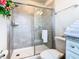 Bathroom featuring a sliding glass shower, a modern toilet, and a granite vanity at 3401 Lilac Way, Davenport, FL 33897