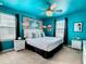 Bright bedroom with turquoise walls, white furniture, modern ceiling fan, and sophisticated decor at 3401 Lilac Way, Davenport, FL 33897