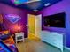 The themed bedroom boasts vibrant LED lighting, and a large screen TV, offering a fun, immersive escape at 3401 Lilac Way, Davenport, FL 33897