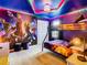 Themed bedroom with bunk beds, vibrant wall art, and a modern ceiling light fixture at 3401 Lilac Way, Davenport, FL 33897