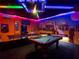 Game room featuring a custom mural, pool table, and vibrant LED lighting, creates a fun, immersive entertainment space at 3401 Lilac Way, Davenport, FL 33897