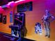 The themed game room boasts a colorful arcade game and Star Wars figures, creating a fun, immersive experience at 3401 Lilac Way, Davenport, FL 33897