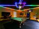 This spacious game room includes a pool table, game tables, and vibrant LED lighting, offering fun and immersive entertainment at 3401 Lilac Way, Davenport, FL 33897