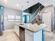 Well-lit kitchen featuring an island with bar seating, granite countertops, and stainless steel appliances at 3401 Lilac Way, Davenport, FL 33897