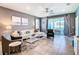 Comfortable living room with tile floors, white sofa, gray chairs, and sliding glass doors to the outdoor patio at 3401 Lilac Way, Davenport, FL 33897