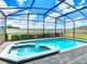 Screened-in pool and spa area with paver decking, offering a private outdoor oasis at 3401 Lilac Way, Davenport, FL 33897