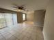 Bright living room featuring tile flooring, ceiling fan, neutral walls, and sliding door access to the backyard at 4013 Dijon Dr # 4013K, Orlando, FL 32808