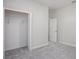 Bright bedroom featuring neutral carpet, open closet with wire rack, and neutral paint at 4898 Lyric Dr, Mascotte, FL 34753