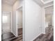 Hallway featuring attractive hardwood floors and white trim throughout the home at 4898 Lyric Dr, Mascotte, FL 34753