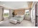 Serene main bedroom features a tray ceiling, soft lighting, and views of the outdoors at 4898 Lyric Dr, Mascotte, FL 34753