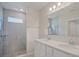 Elegant bathroom with dual sinks, granite counters, and a tiled shower at 4906 Lyric Dr, Mascotte, FL 34753