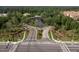 Aerial view of the community entrance, showcasing landscaping, water feature and surrounding greenery at 4978 Fawn Ridge Pl, Sanford, FL 32771