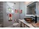 Bathroom with a patterned vessel sink, and decorative mirror and artistic decorations at 4978 Fawn Ridge Pl, Sanford, FL 32771