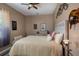 Bedroom with a full size bed, neutral colors and decorative guitar artwork at 4978 Fawn Ridge Pl, Sanford, FL 32771