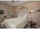 Bedroom with a full size bed and decorative guitar artwork and bedside lighting at 4978 Fawn Ridge Pl, Sanford, FL 32771