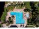 Aerial view of the community pool including multiple lap lanes, chairs, tables, and lush landscaping at 4978 Fawn Ridge Pl, Sanford, FL 32771