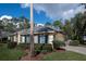 Lovely beige home with blue shutters, a brick driveway, and lush landscaping at 4978 Fawn Ridge Pl, Sanford, FL 32771