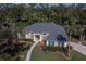 Aerial view of a meticulously maintained one-story home with lush landscaping, a brick walkway, and a well-kept roof at 4978 Fawn Ridge Pl, Sanford, FL 32771